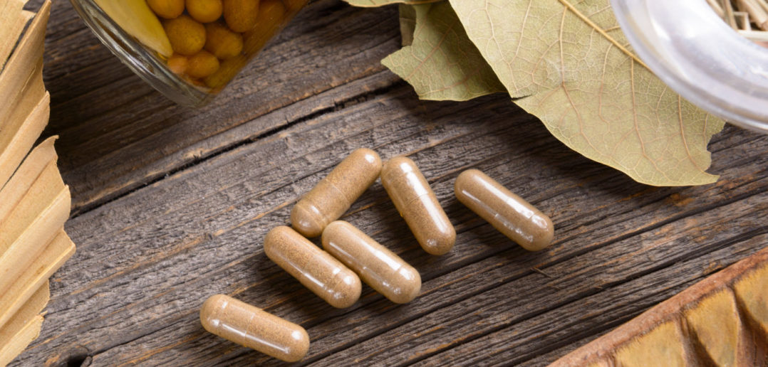 Natural herbal capsules with  herb leaves