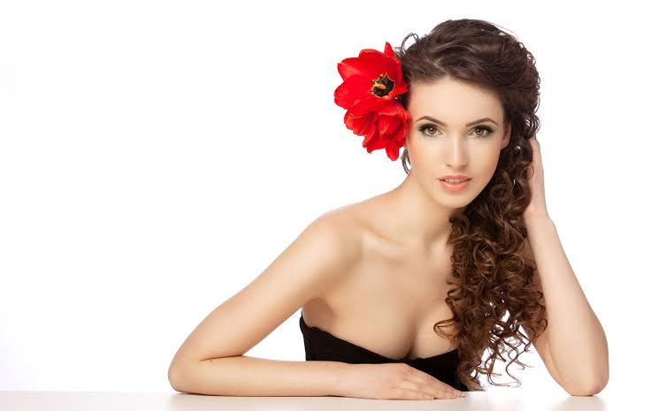 Beautiful woman with  red flowers